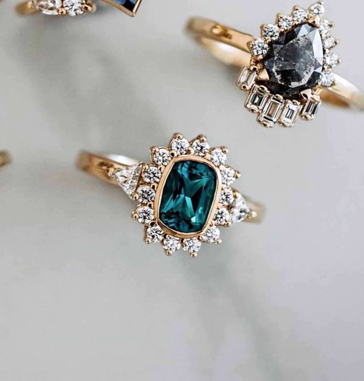 Gold rings with silver and black stones, decorated with small diamonds
