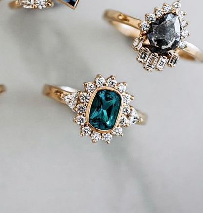 Gold rings with silver and black stones, decorated with small diamonds